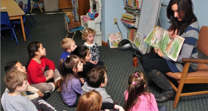 Story Time! Teacher reads to a group of children at Miss Cindy's School